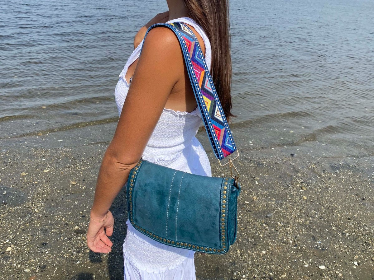 Woman wearing an Italian leather crossbody bag with an adjustable strap, showing where the bag sits at the hip