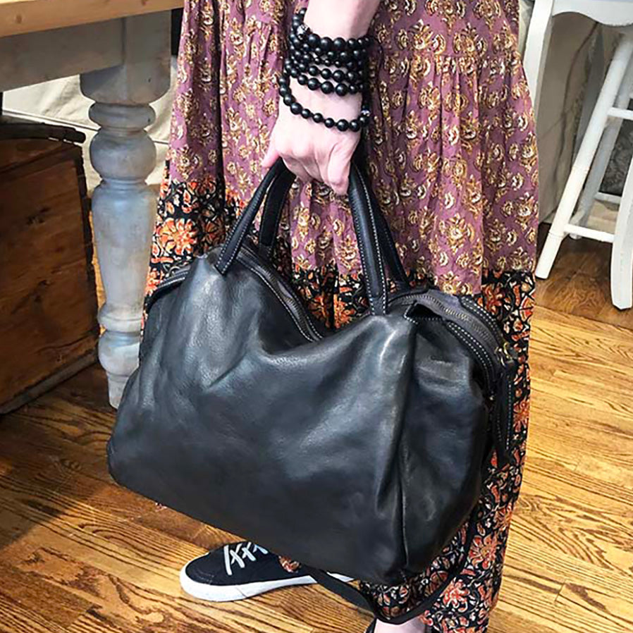 Model holding Flora Satchel in Black